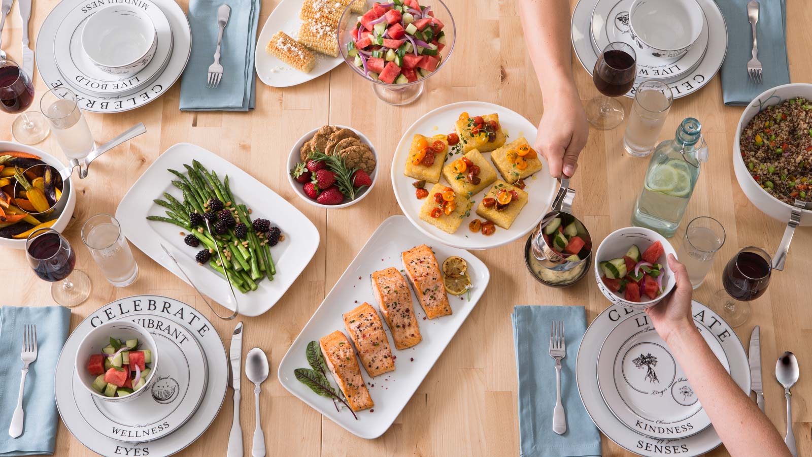 A dinner table filled with delicious food, being served on Livliga portion control dinnerware.